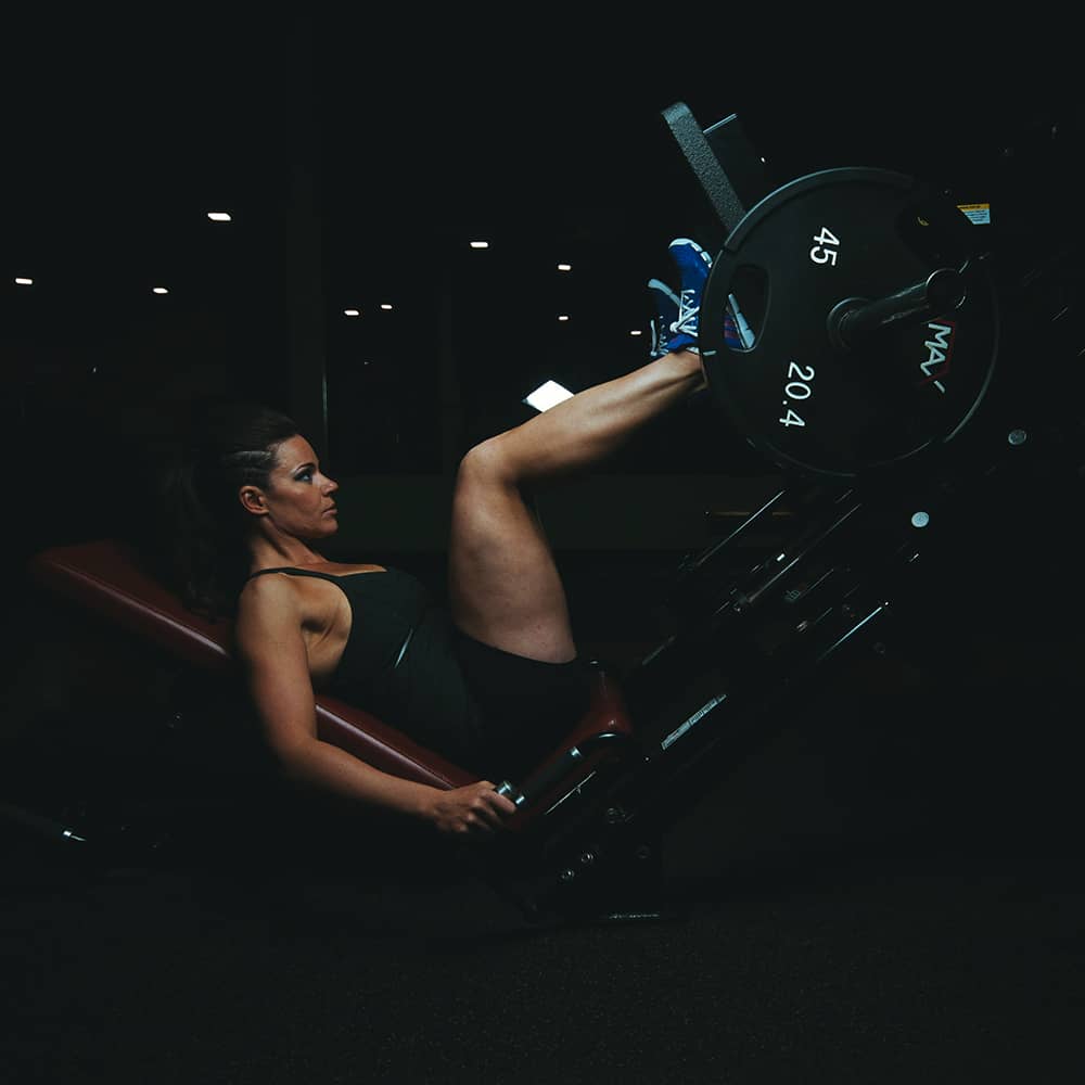 Image of a woman doing leg presses