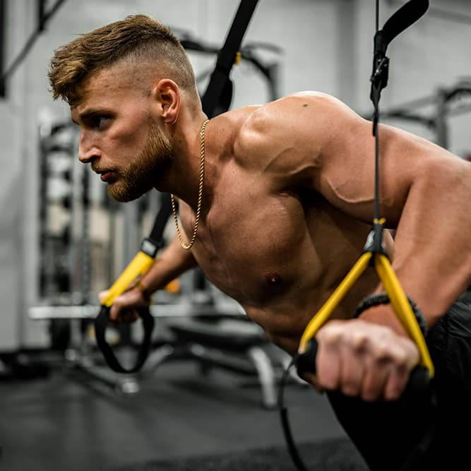 Image of a man performing a cable crossover exercise at the gym