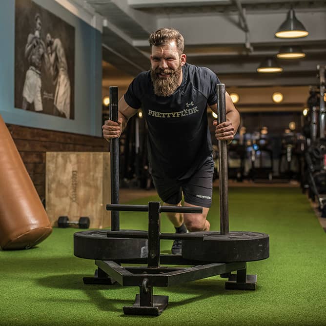 Image of a man performing strength training at the gym